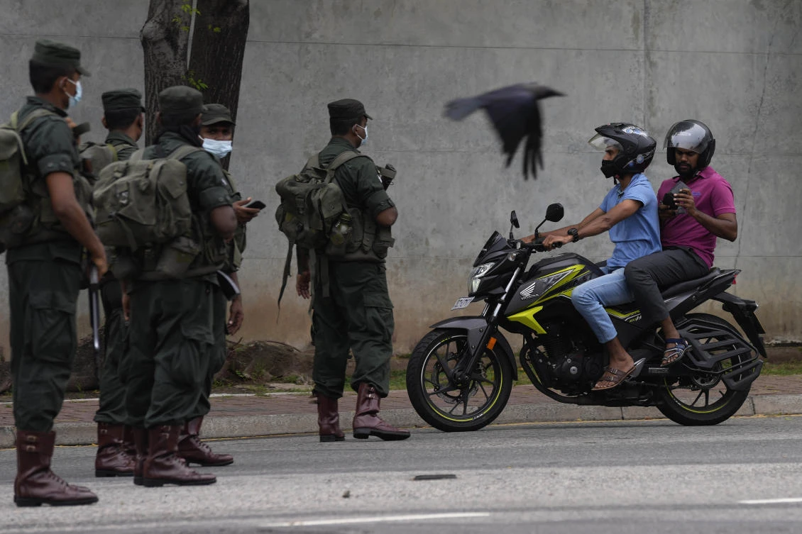 Sri Lankan army soldiers man a checkpoint during curfew imposed a day after clashes between government supporters and anti government protesters in Colombo on May 10, 2022. (AP)