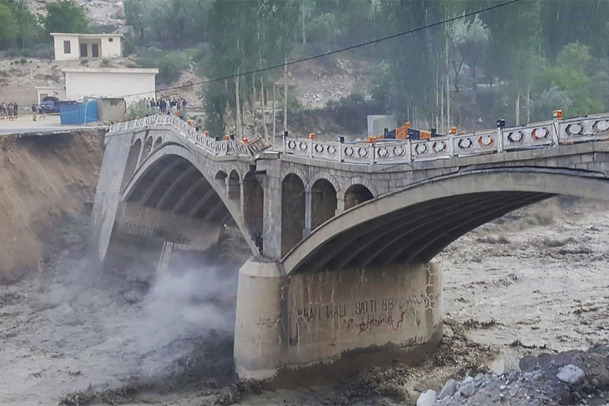This picture taken on May 7, 2022, shows a bridge partially collapsed due to flash floods in Hassanabad village, in Pakistan's northern Hunza district. (AFP)