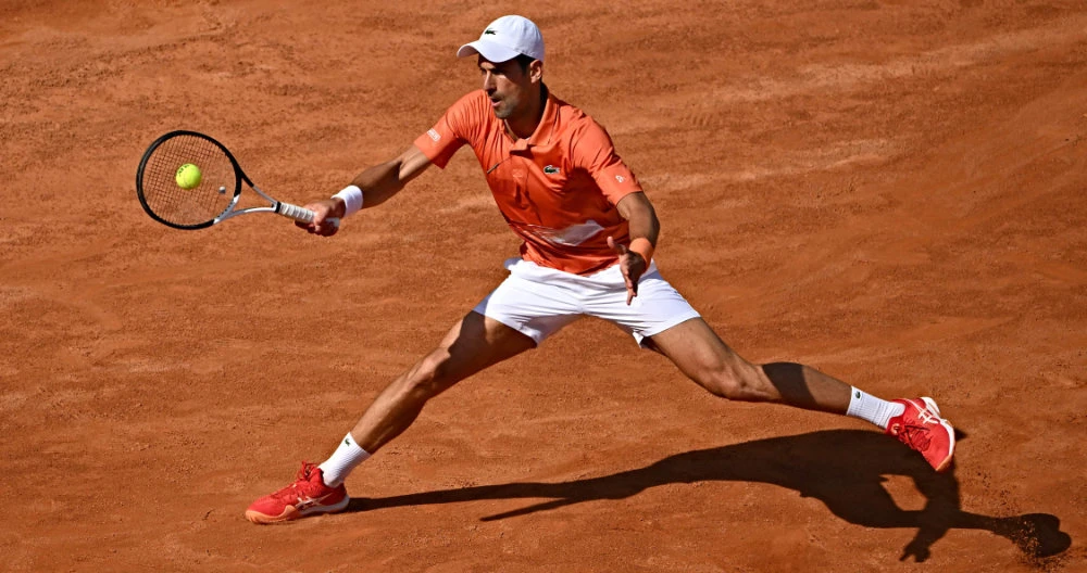 Serbia's Novak Djokovic in action against Russia's Aslan Karatsev during their first round match at the ATP Rome Open tennis tournament on May 10, 2022 at Foro Italico in Rome. (AFP)