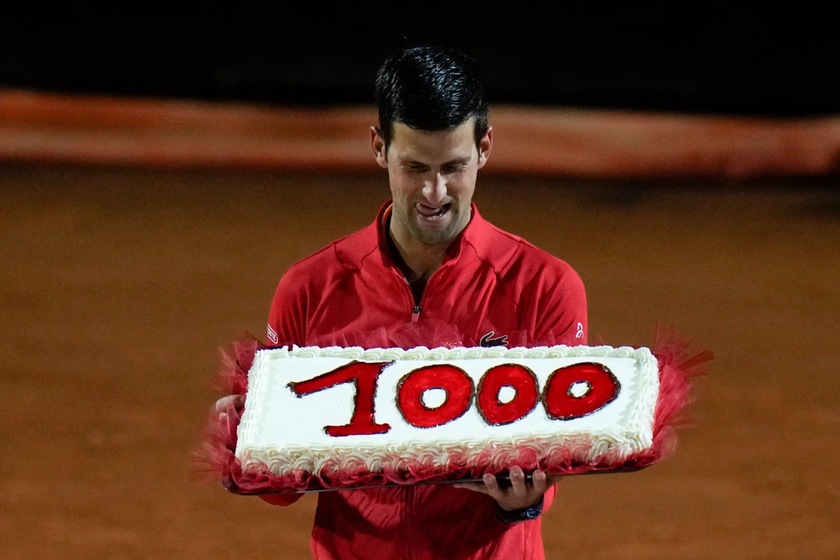 Novak Djokovic with a cake adorned with the number of his 1,000th tour-level wins earned after winning the semifinal match against Norway's Casper Ruud at the Italian Open tennis tournament in Rome on May 14, 2022. (AP)