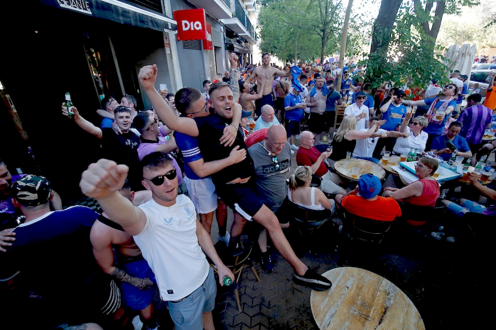 Glasgow Rangers supporters shout and cheer outside a bar in downtown Seville, Spain, on Tuesday. Eintracht Frankfurt will play Glasgow Rangers in the Europa League final Wednesday evening in Seville. (AP)