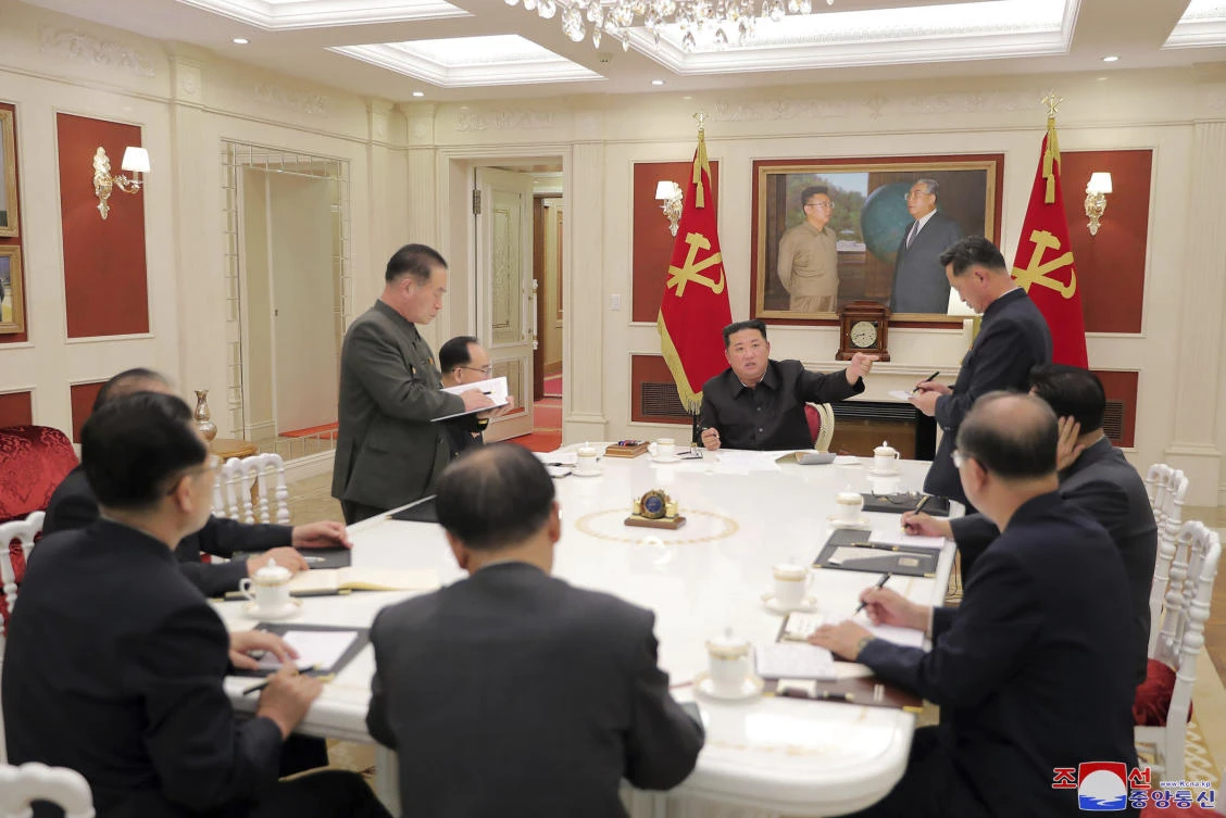 North Korean leader Kim Jong Un, center, attends a ruling party meeting in Pyongyang, which claimed the country could overcome the crisis on its own. (Korean Central News Agency/Korea News Service via AP)