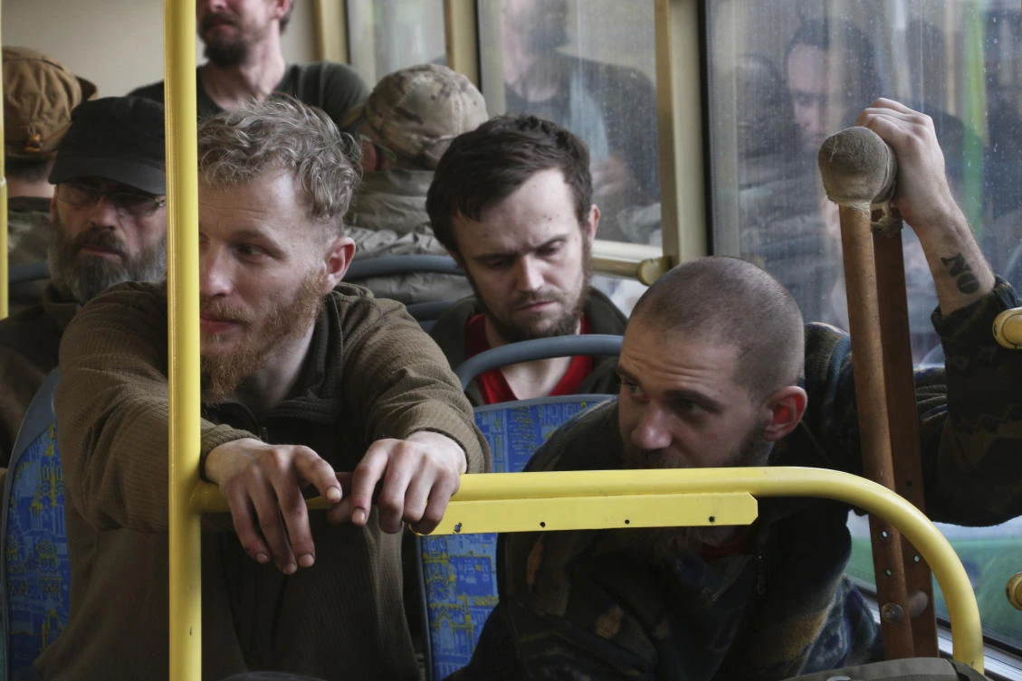 Ukrainian servicemen sit in a bus after they were evacuated from the besieged Mariupol's Azovstal steel plant, eastern Ukraine, Tuesday, May 17, 2022. (AP Photo)