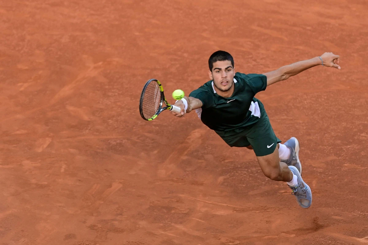 Spain's Carlos Alcaraz returns the ball to Germany's Alexander Zverev during their 2022 ATP Tour Madrid Open tennis tournament men's singles final match on May 8, 2022. (AFP)