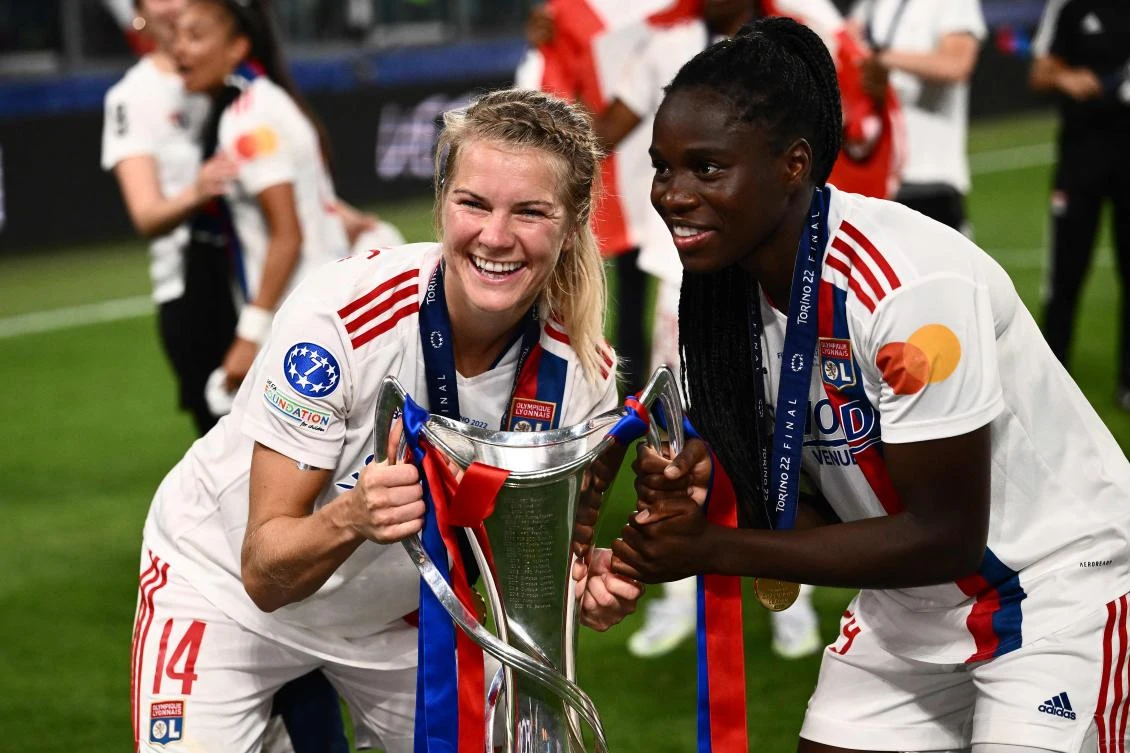 Lyon’s Norwegian forward Ada Hegerberg and French forward Eugenie Le Sommer pose with the winner’s trophy after their team won the UEFA Women’s Champions League Final against Barcelona at the Allianz Stadium in Turin on Saturday. (AFP)