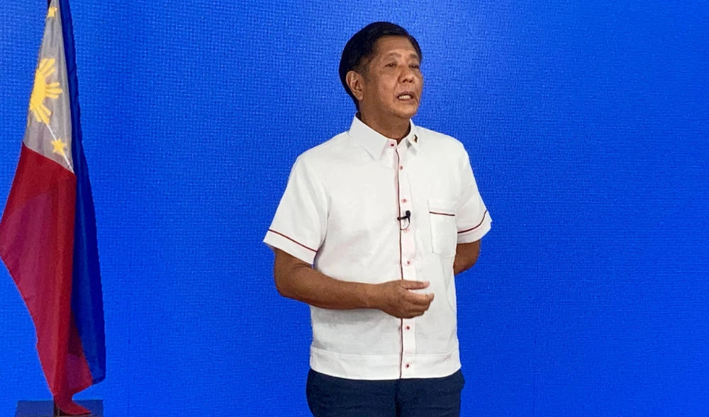 In this photo taken May 9, 2022, Presidential candidate Ferdinand Marcos Jr., son of the late dictator Ferdinand Marcos Sr., speaks to the members of the media, at his party heaquarters in Manila. (AFP)