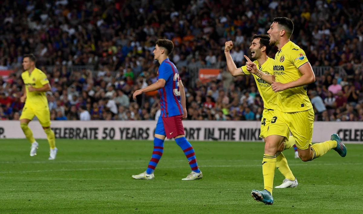 Villarreal's midfielder Gomez (R) celebrates after scoring his team's second goal during the Spanish League football match against FC Barcelona at the Camp Nou stadium in Barcelona on May 22, 2022. (AFP)