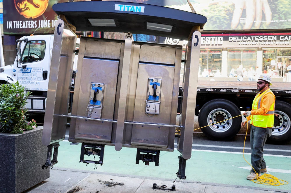 A worker removes the last public payphone near Times Square in New York City, U.S., May 23, 2022. (REUTERS)