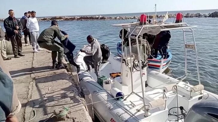 A Tunisian national coast helps a migrant child to get off a rescue boat. (File: Reuters)