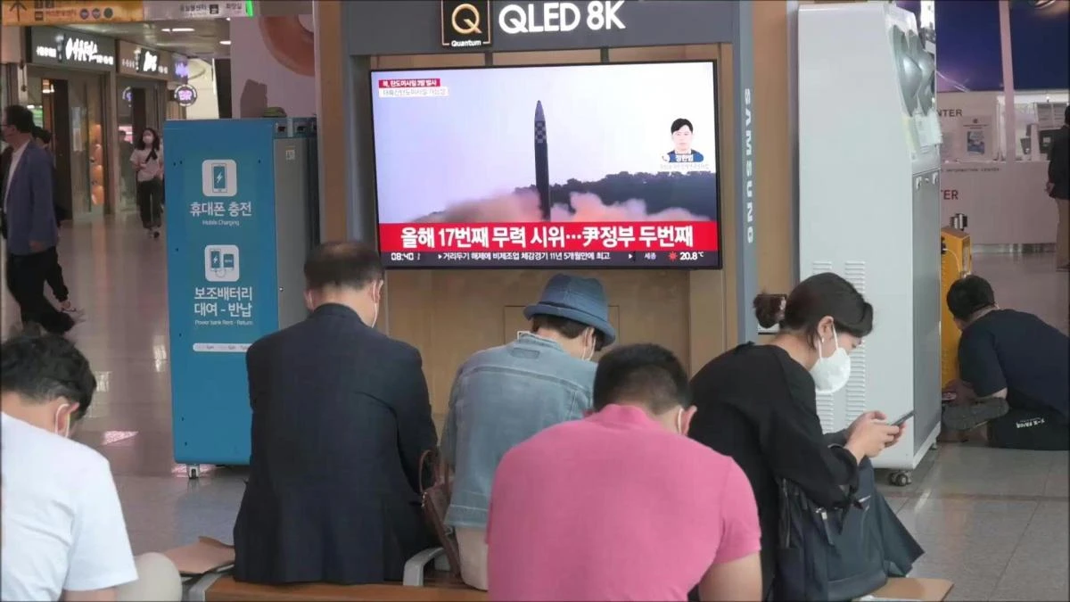 South Koreans watch news of North Korean missile test broadcast on TV screen at a train station in Seoul. (AFP)
