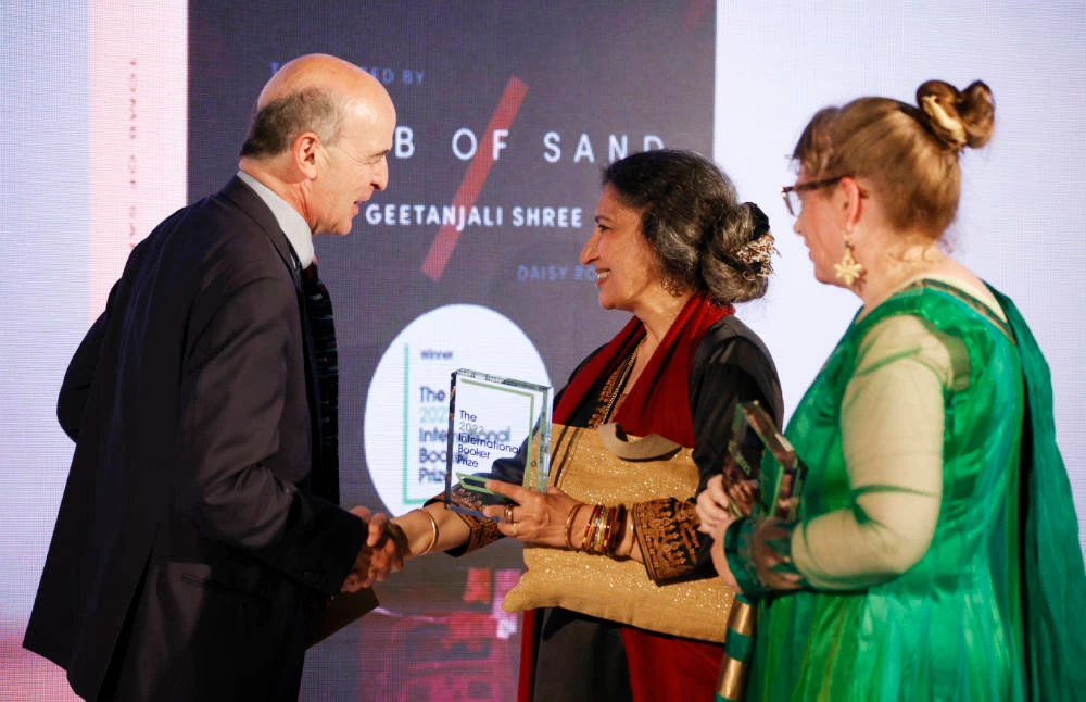 Author Geetanjali Shree, centre, and translator Daisy Rockwell receive the 2022 International Booker Prize author and translator awards for Shree's novel 'Tomb of Sand' from Booker Prize Foundation chair Mark Damazer in London, May 26, 2022. (AP)