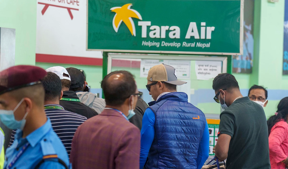 A signage of Tara Airlines is seen behind as a team of climbers prepare to leave for rescue operations from the Tribhuvan International Airport in Kathmandu, Nepal, Sunday, May 29, 2022. (AP)
