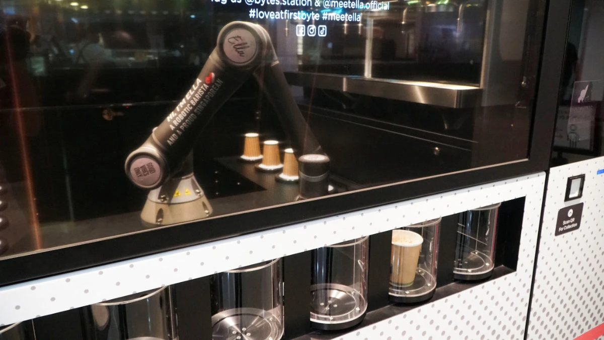 Robot barista "Ella", designed by Crown Digital, makes a coffee autonomously after receiving orders. (REUTERS/Travis Teo)
