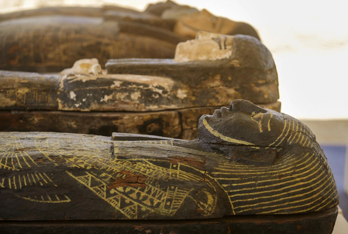 Painted coffins with well-preserved mummies inside, dating back to the Late Period of ancient Egypt around 500 B.C, are displayed at a makeshift exhibit at the feet of the Step Pyramid of Djoser in Saqqara. (AP)