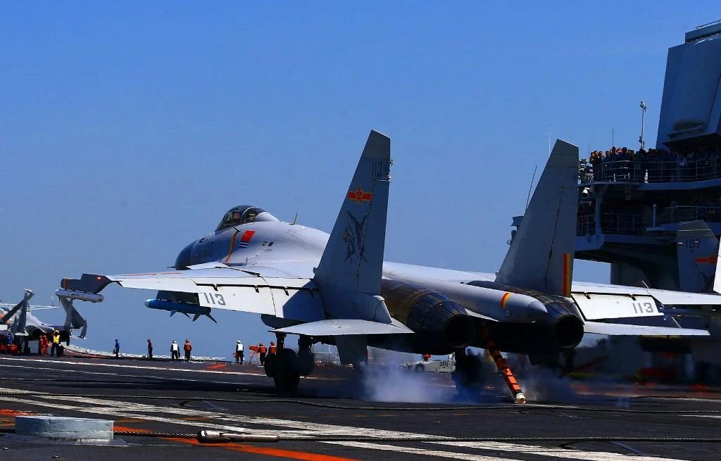 A J15 fighter jet lands on China’s sole operational aircraft carrier, the Liaoning, during a drill in the East China Sea. Last year, Taiwan recorded 969 incursions by Chinese warplanes into its air defense zone. (AFP)