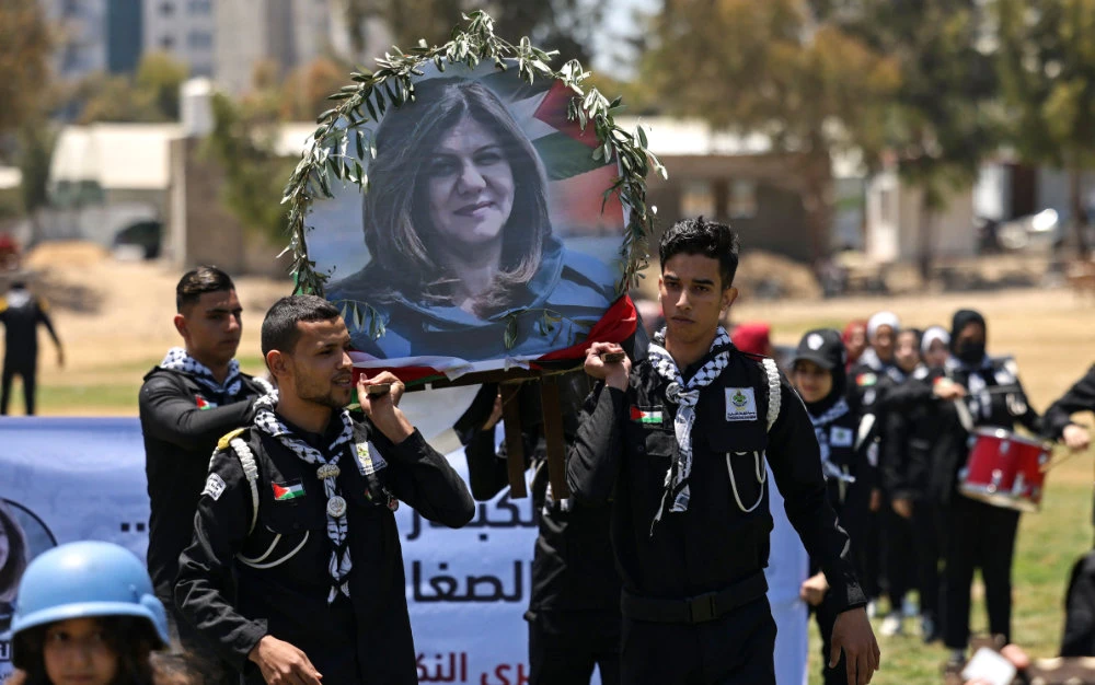 Palestinian youth hold a mock funeral for slain Al-Jazeera reporter Shireen Abu Akleh in Gaza City on May 17, 2022. (AFP)