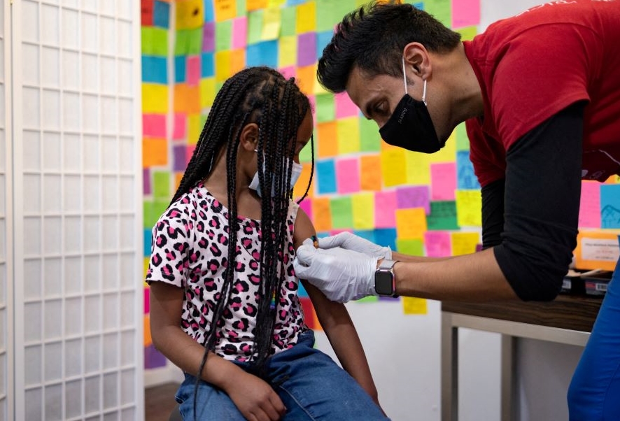 A doctor puts a band-aid on a young girl after she received a COVID-19 vaccine, Schwenksville, U.S., May 19, 2022. (Reuters)