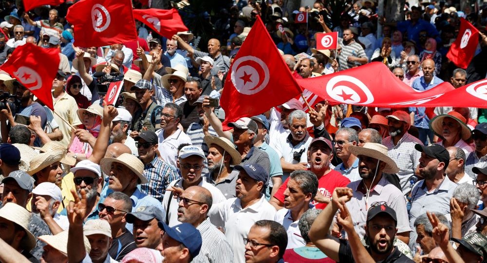 Demonstrators wave flags and shout slogans during a protest against Kais Saied, Tunis, Tunisia, June 19, 2022. (Reuters)