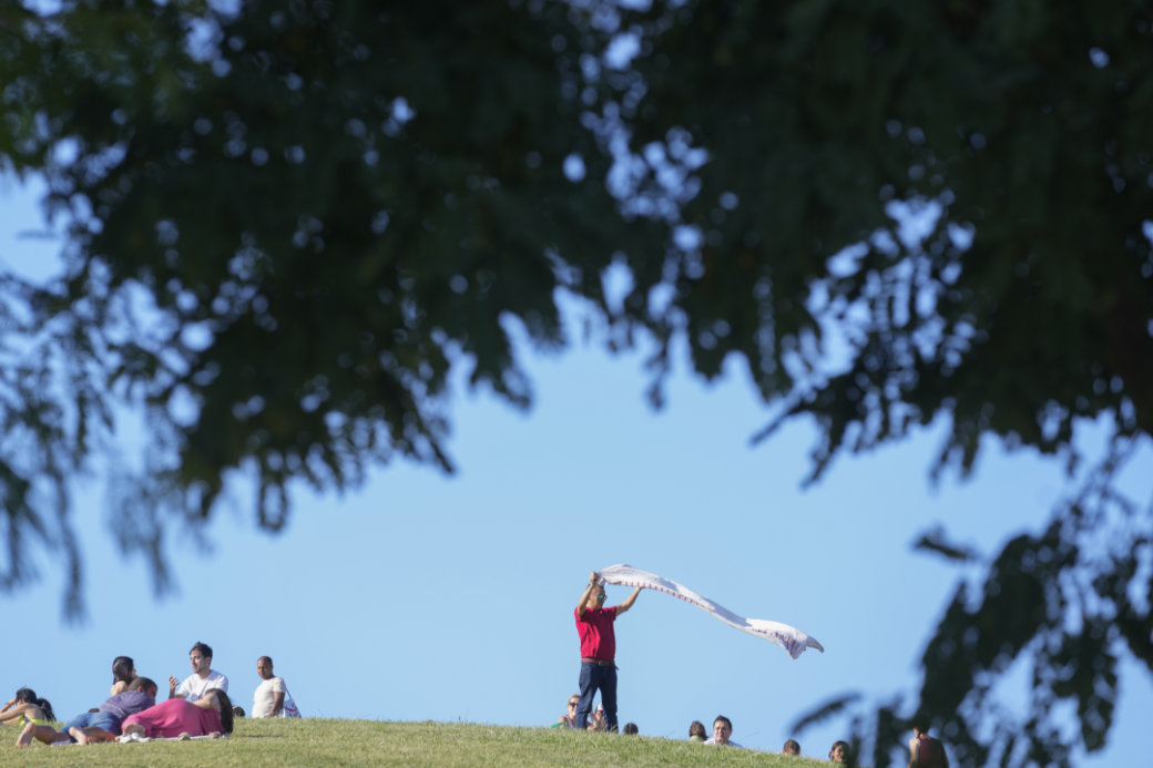 People relax in a park in Madrid, Spain, Sunday, June 19, 2022. (AP)