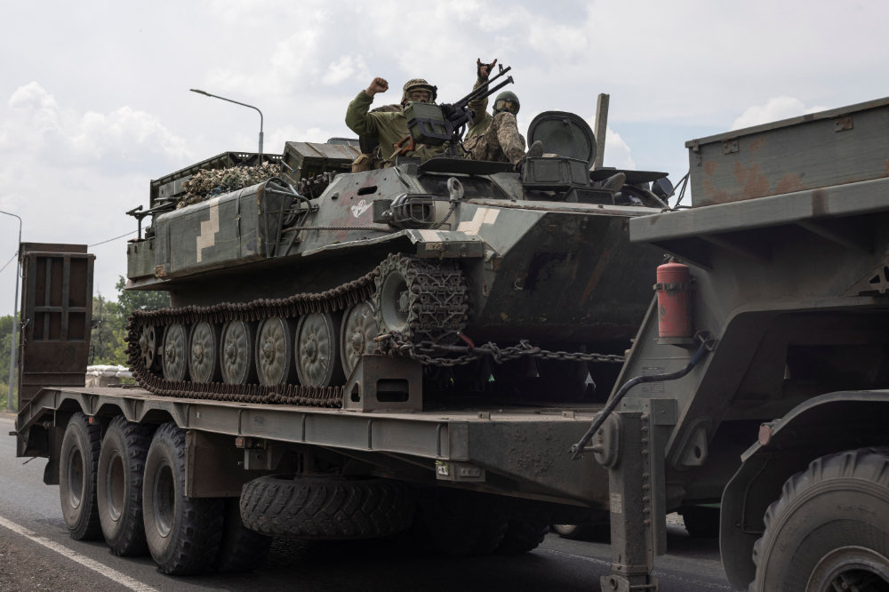 Ukrainian servicemen travel on their armored personnel carrier, amid Russia's invasion of the country, in Ukraine. (Reuters)