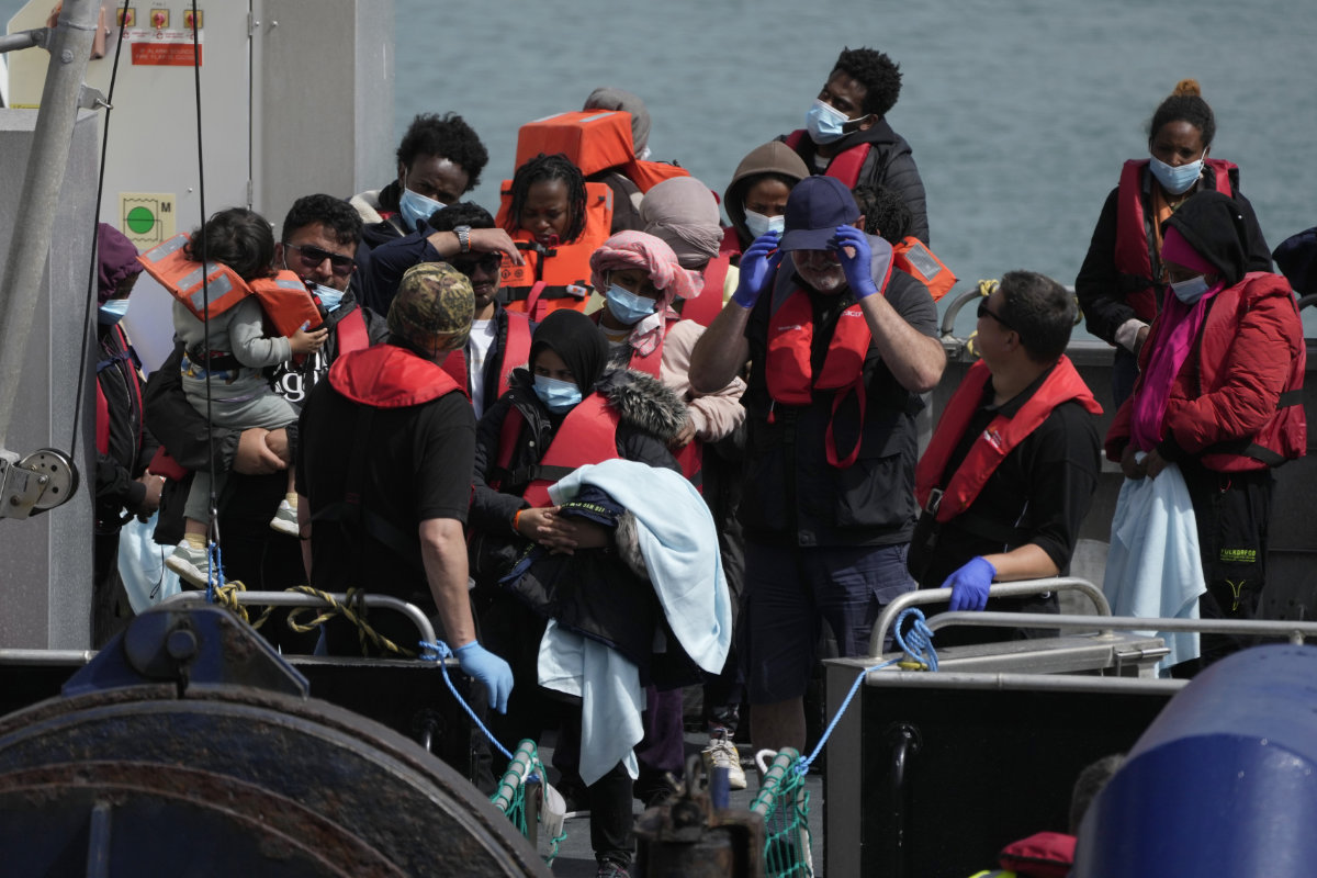 Migrants wait to be disembarked from a British border force vessel in Dover, England, on June 17, 2022. (AP)