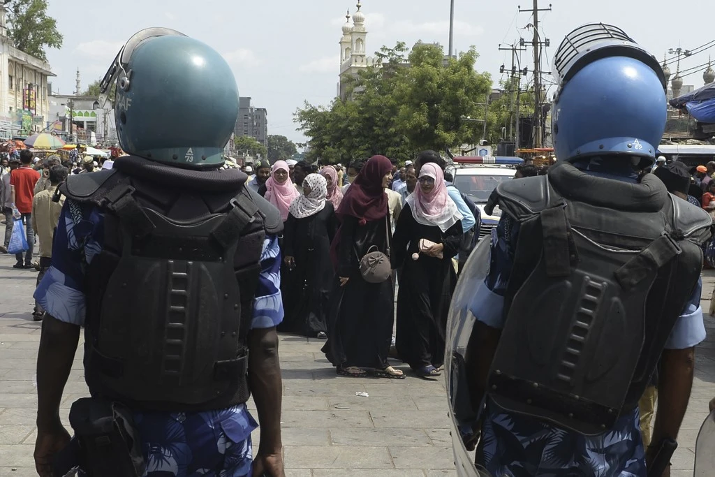 Security personnel stand guard as devotees leave after offering Friday prayers in Hyderabad on June 10, 2022. (AFP)