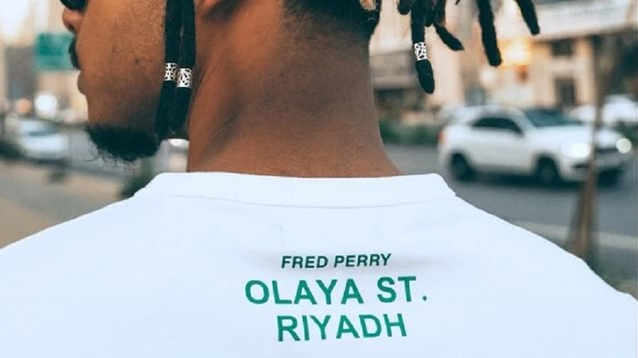 The shirt has the Olaya Street shop address printed across the back. Supplied