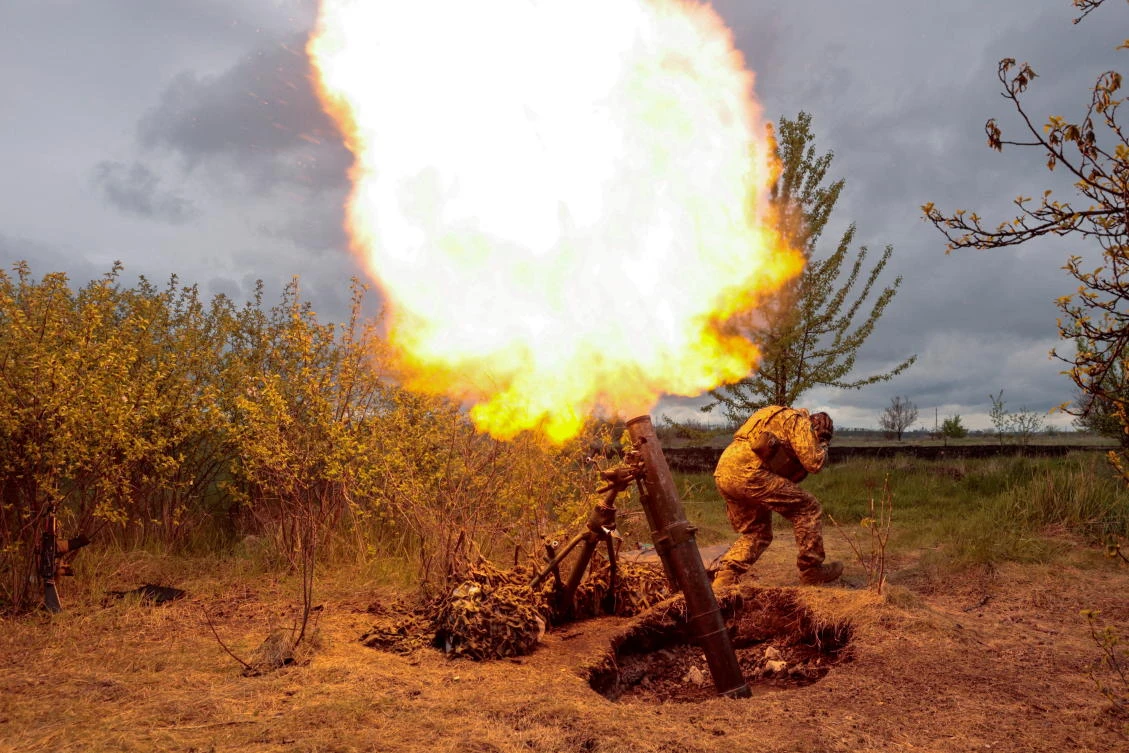 A Ukrainian serviceman fires with a mortar at a position, as Russia’s attack on Ukraine continues, at an unknown location in Kharkiv region. (Reuters)