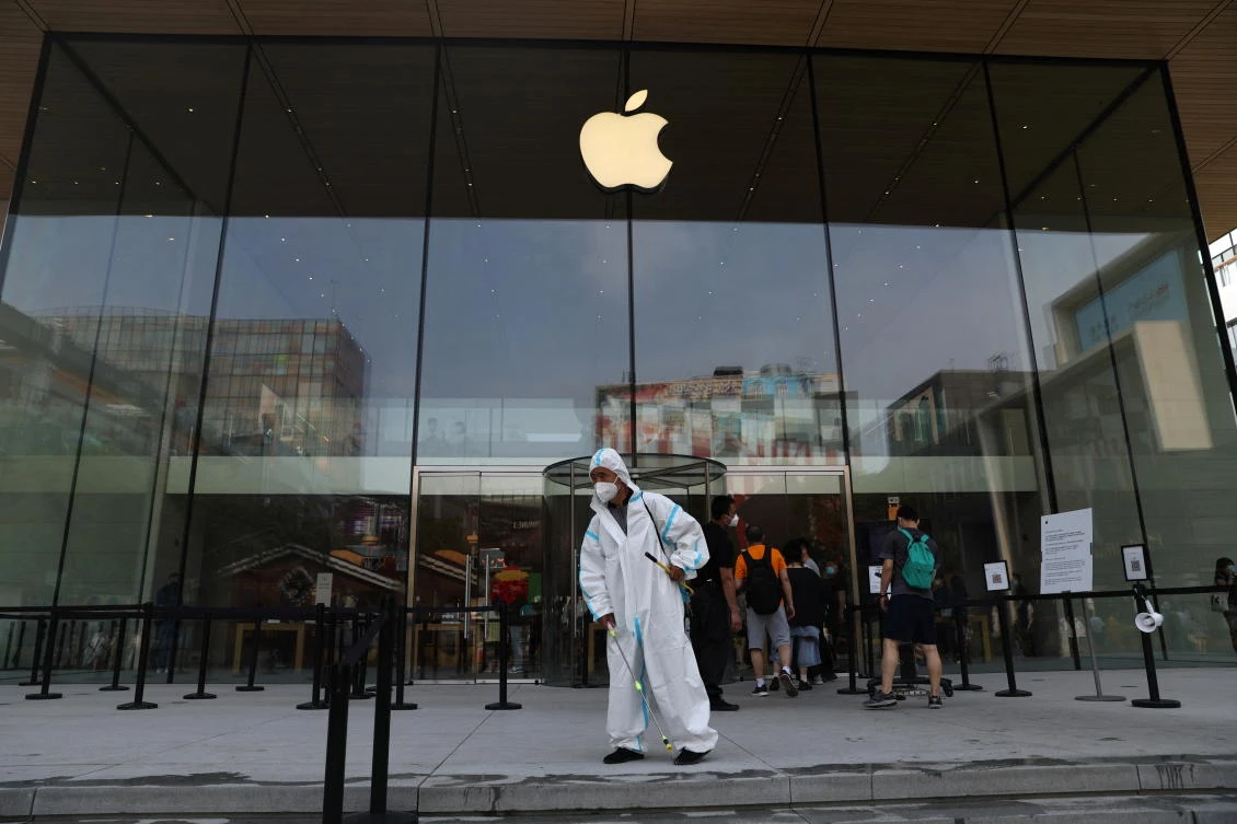 China’s zero COVID-19 strategy meant restrictions on movement in major cities including Shanghai and Beijing. Above, a worker in a protective suit disinfects the ground in front of Apple store in Beijing. (Reuters)