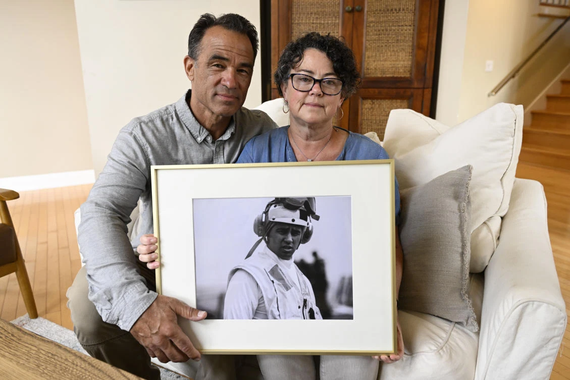 Derek and Suzi Alkonis hold a photo of their son Lt. Ridge Alkonis, who faces a potential three-year prison sentence for a car crash that killed two people in Japan last year. (AP)