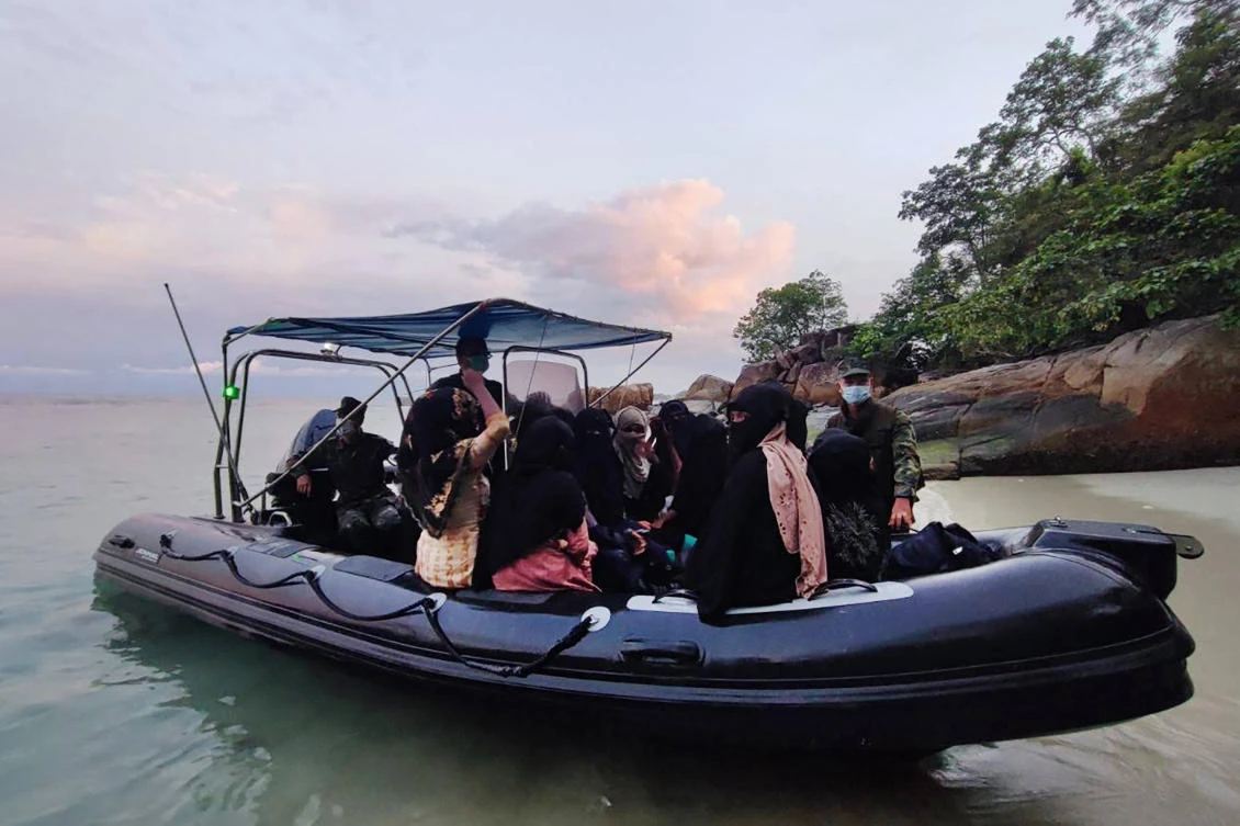 Thai naval personnel transfer Rohingya, who were found stranded on the Thai island of Koh Dong, to the southern Thai city of Satun, June 4, 2022. (AFP)