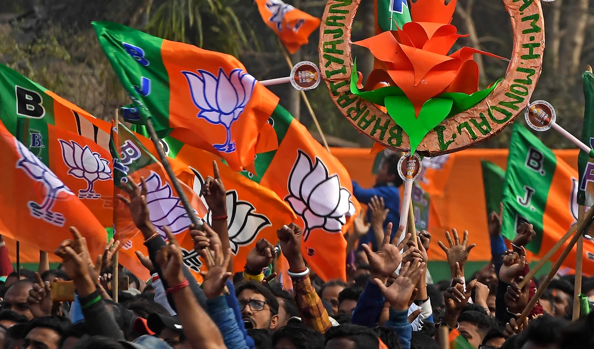 Activists of Bharatiya Janata Party (BJP) wave party flags during a rally in Howrah on the outskirts of Kolkata, India, on January 31, 2021. (AFP/File)