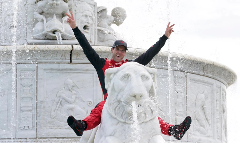 Will Power celebrates in the James Scott Memorial Fountain after winning the IndyCar Detroit Grand Prix auto race on Belle Isle in Detroit Sunday. (AP)
