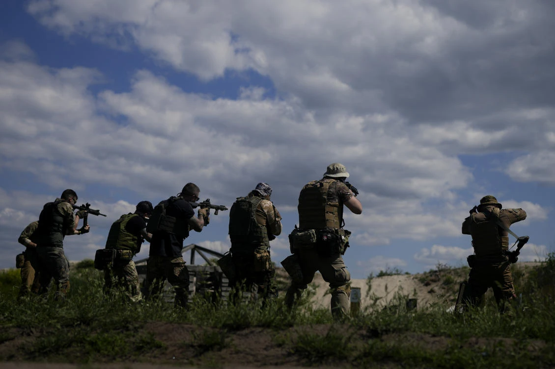 Civilian militia men hold shotguns during training at a shooting range in outskirts Kyiv on Tuesday. (AP)