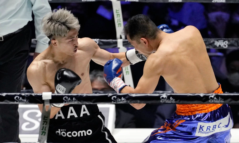 Japan’s Naoya Inoue, left, and Philippines’ Nonito Donaire during their bantamweight unification boxing match at Saitama Super Arena in Saitama on Tuesday. (AP)