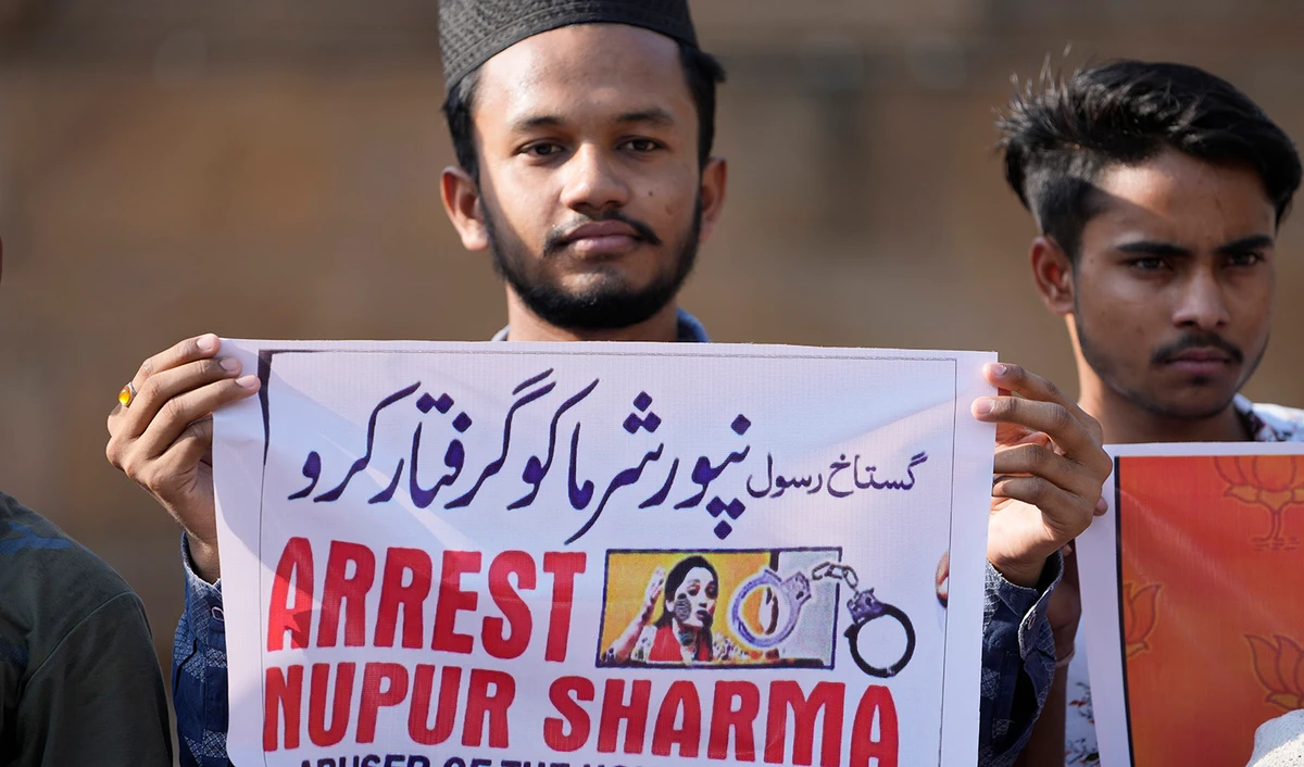 Indian Muslims hold placards demanding the arrest of BJP leader Nupur Sharma, as they react to the derogatory references to Islam and the Prophet Muhammad (PBUH) made by her, during a protest in Ahmedabad, India, on June 8, 2022. (AP)