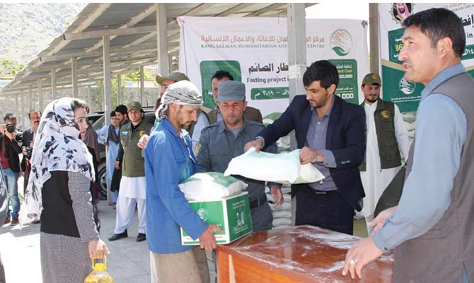 In this undated file photo, volunteers of KSRelief distribute humanitarian aid among people in Afghanistan. (SPA/File)