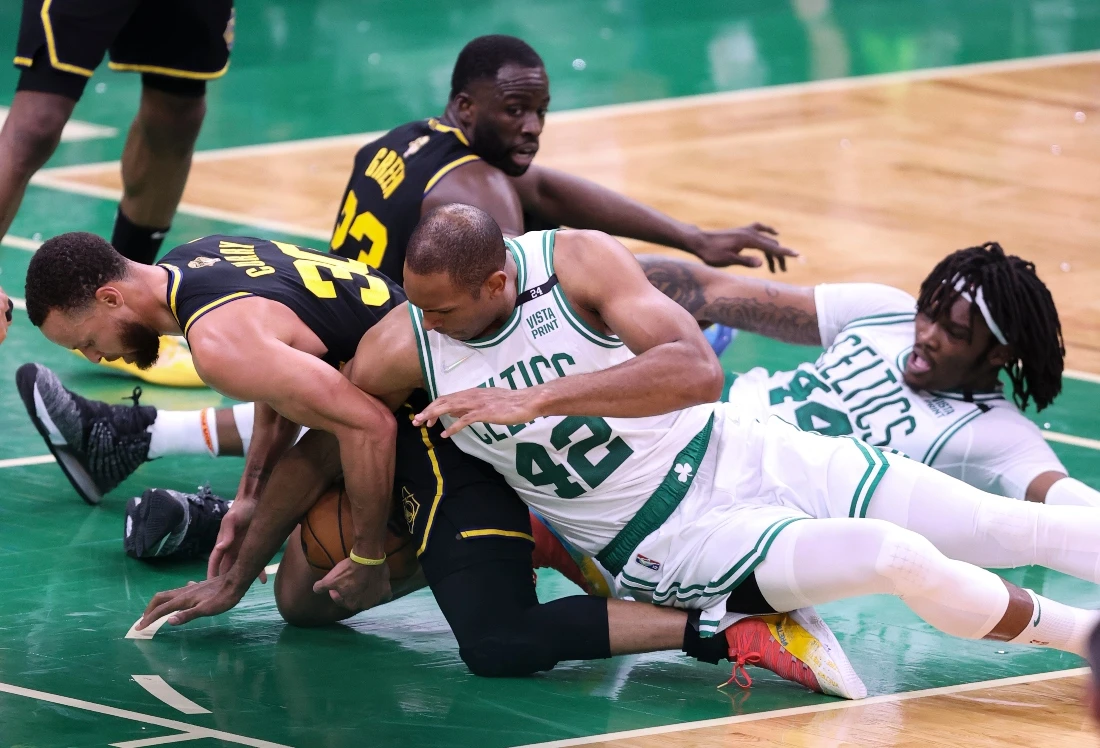 Golden State Warriors' Stephen Curry, left, is caught under Boston Celtics' Al Horford (42) during the fourth quarter of Game 3 of the NBA Finals Wednesday in Boston. (AP)