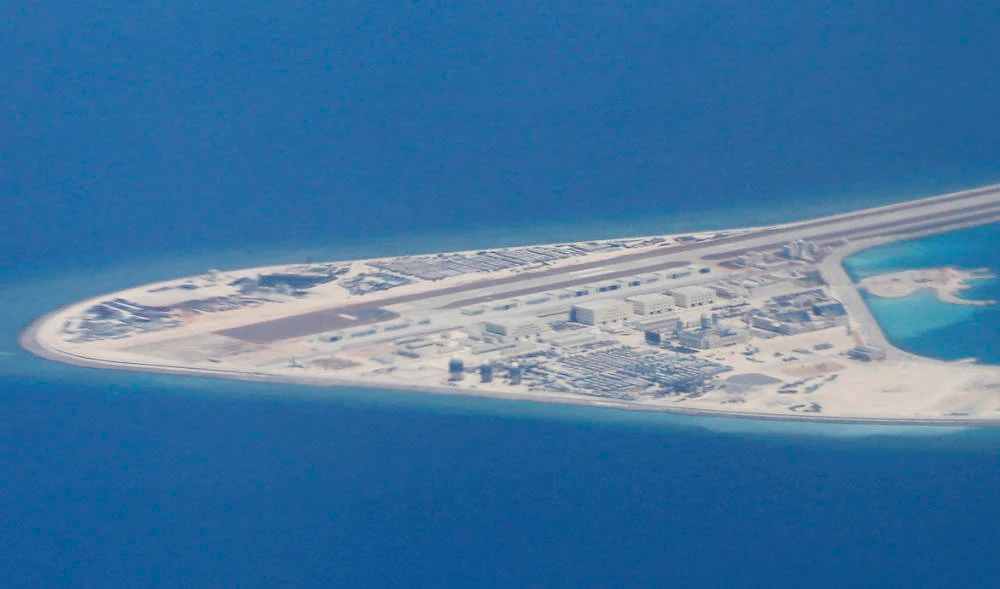 Chinese structures and an airstrip on the man-made Subi Reef at the Spratly group of islands in the South China Sea are seen from a Philippine Air Force C-130. (AP file photo)