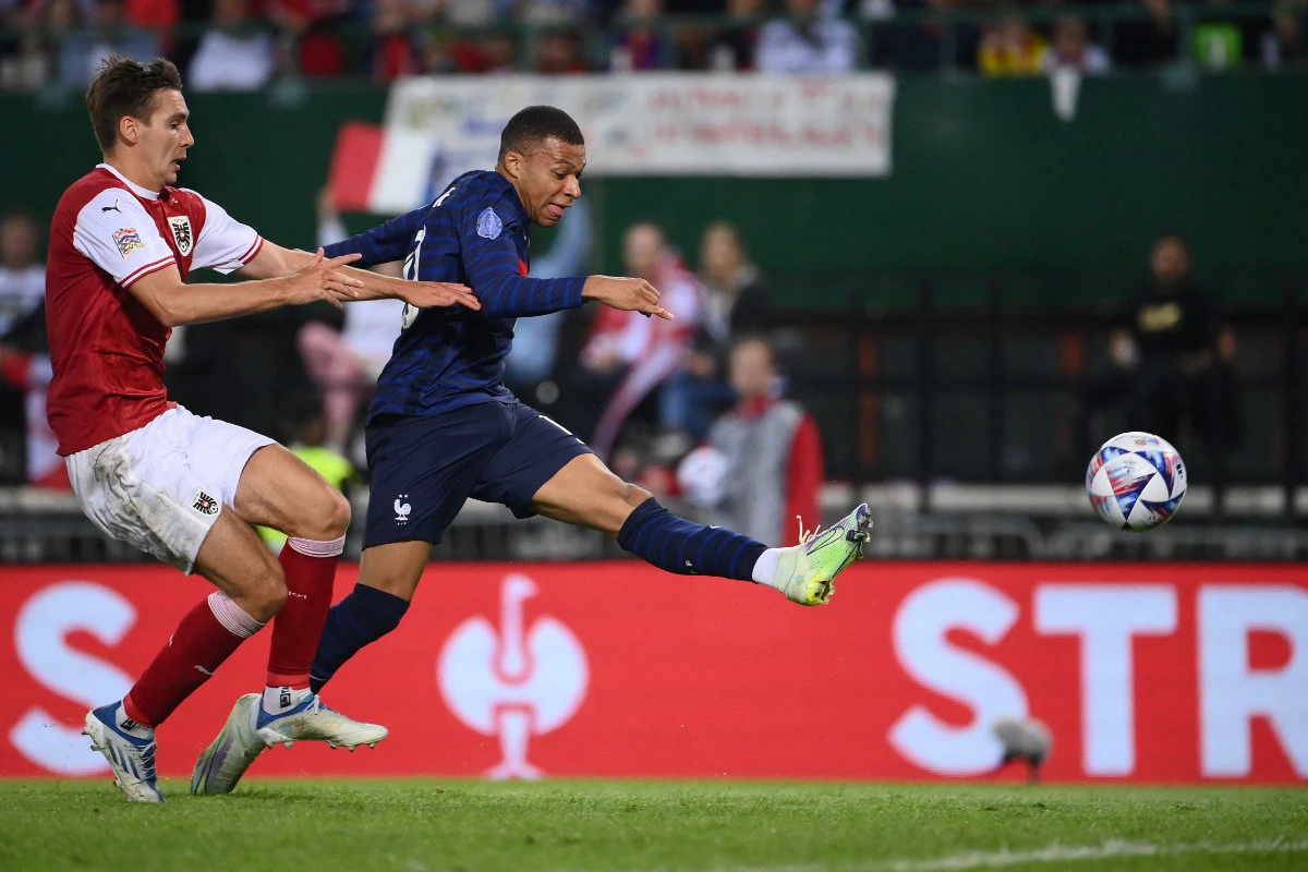 France's forward Kylian Mbappe gets past Austria's defender Maximilian Woeber to shoot and score the 1-1 equalizer during their UEFA Nations League football match in Vienna on June 10, 2022. (AFP)