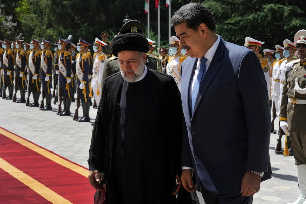 Venezuela’s President Nicolas Maduro, right, is welcomed by his Iranian counterpart Ebrahim Raisi at the Saadabad Palace in Tehran on June 11, 2022. (AP)