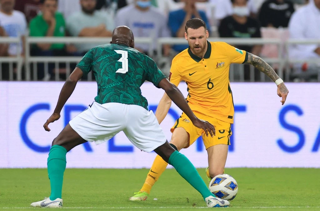 Australia’s forward Martin Boyle, right, vies for the ball with Saudi Arabia’s defender Abdullah Madu during their teams’ 2022 Qatar World Cup Asian Qualifiers match on March 29, 2022. (AFP)