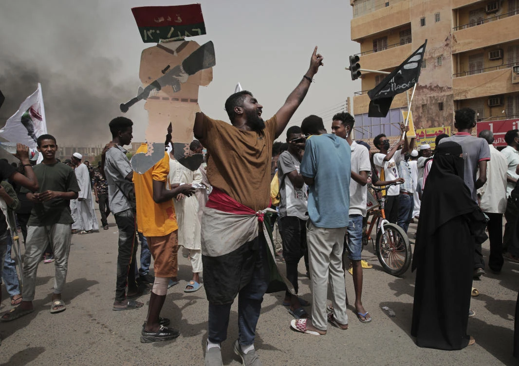 Sudanese protesters commemorate the third anniversary of a deadly crackdown carried out by security forces on protesters during a sit-in outside the army headquarters, in Khartoum on June 3, 2022. (AP)