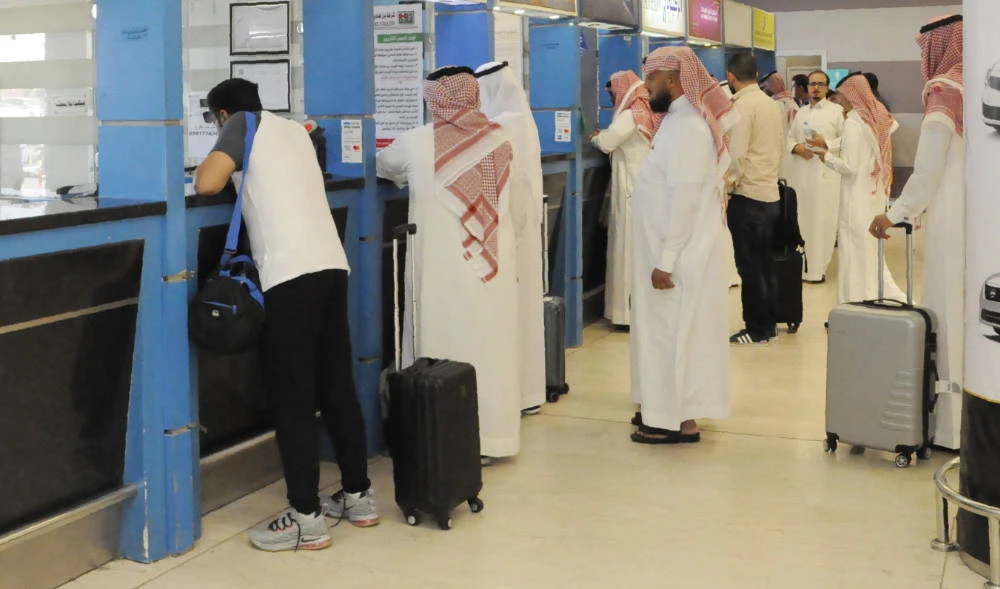 Travellers queue at car rental stands inside the Abha airport in Saudi Arabia. (AFP)