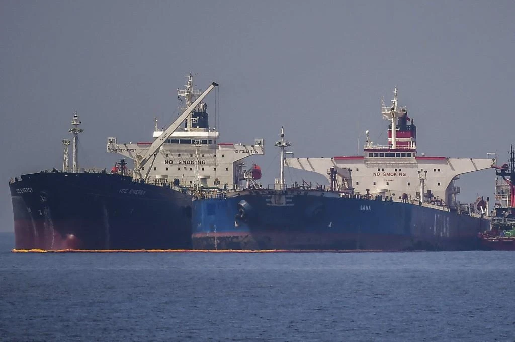 The ship, right, previously called Pegas and renamed Lana in March, was headed to the southern Peloponnese peninsula to offload its cargo but rough seas forced it to moor just off Karystos where it was seized. (AFP)