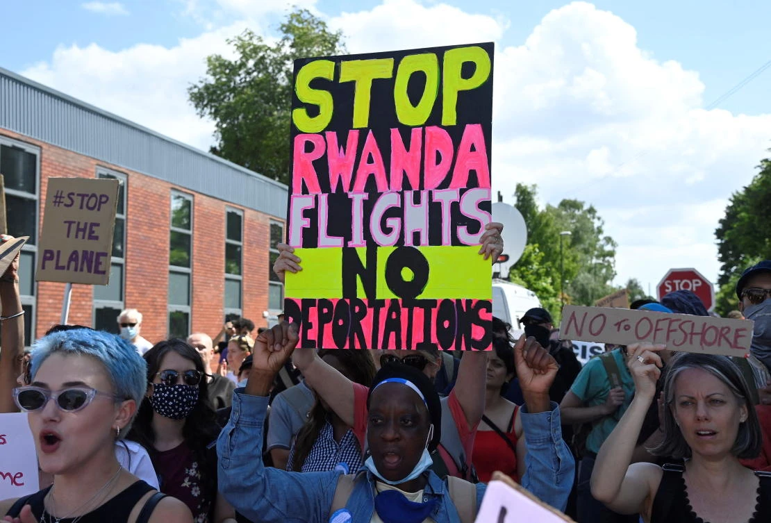 Demonstrators protest outside of an airport perimeter fence against a planned deportation of asylum seekers from Britain to Rwanda, at Gatwick Airport near Crawley, Britain, on Sunday. (Reuters)