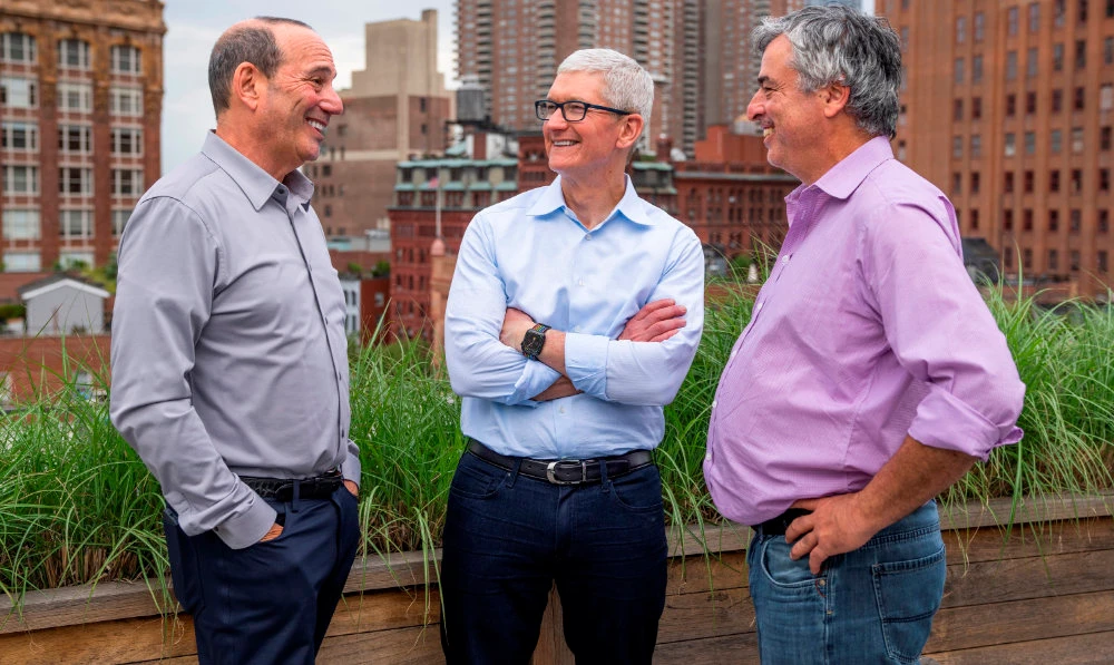 In this photo provided by Apple Inc., Major League Soccer commissioner Don Garber, left, Apple CEO Tim Cook, center, and Apple senior vice president of Services Eddy Cue talk in New York, June 8, 2022. (AP)