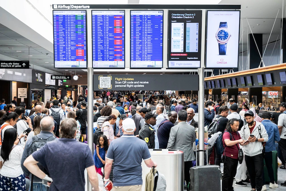 Passengers wait for updates on their flights at Zurich airport on June 15, 2022 after it was closed for safety reasons due to an unspecified ‘technical malfunction’. (Keystone via AP)