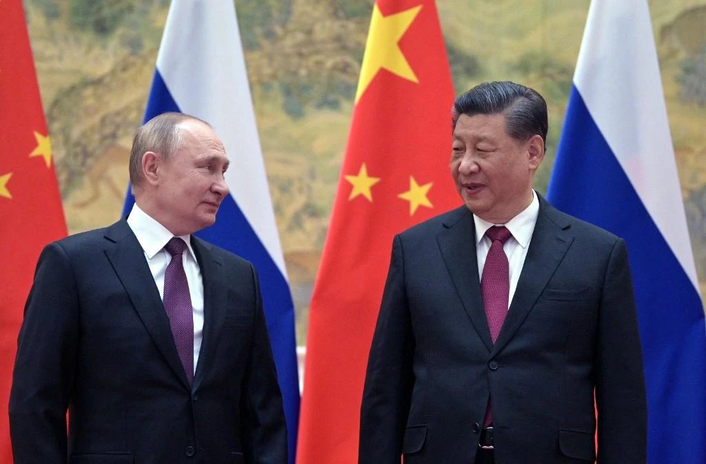 Russian President Vladimir Putin, left, and Chinese President Xi Jinping pose for a photograph during their meeting in Beijing on February 4, 2022. Beijing reiterated on Wednesday that would keep backing Moscow on ‘sovereignty and security.’ (AFP)