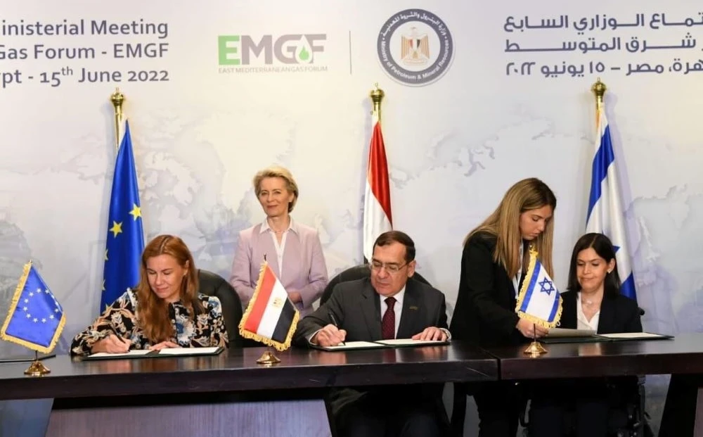Kadri Simson, Tarek El Molla and Karine Elharrar sign the tripartite memorandum of understanding. (Supplied)